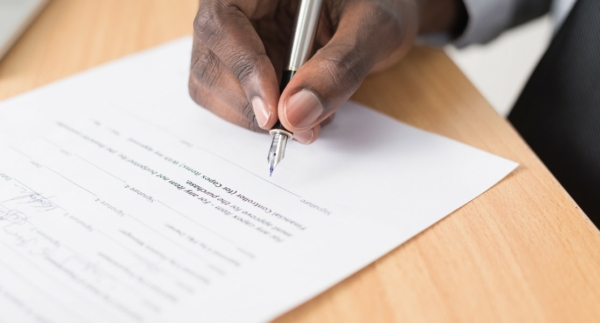 Image of person signing contract or commercial lease