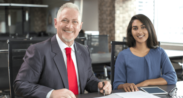 Older white male mentoring young indian female in finance